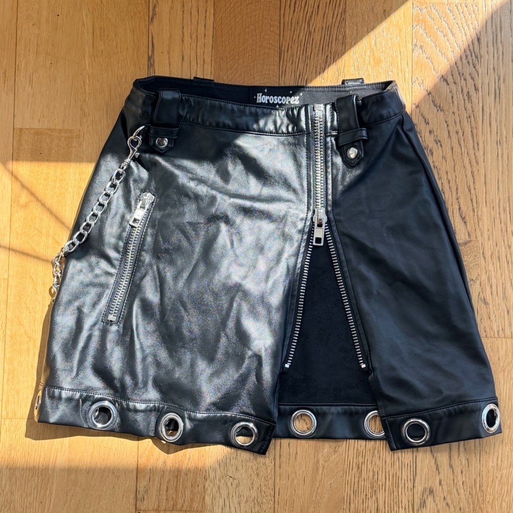 Dolls Kill Horoscope Black Faux Leather Grommet Mini Skirt